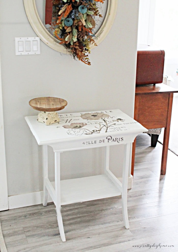 An antique side table makeover in white with french graphics.
