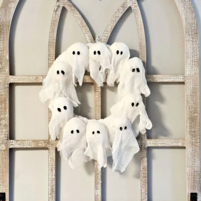 A wreath made of ten small ghosts all in a circle using Dollar Tree supplies.