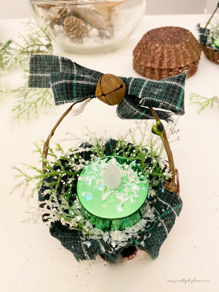 DIY vintage tart tin Christmas tree ornaments with tartan fabric, glittered brown tins, and small flameless candles.