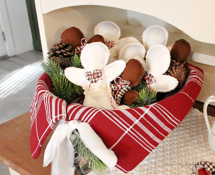 Fabric gingerbread men scented with cinnamon and essential oils displayed in a cream ironstone bowl.