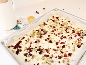 White chocolate Ritz cracker toffee topped with cranberries and pistachios