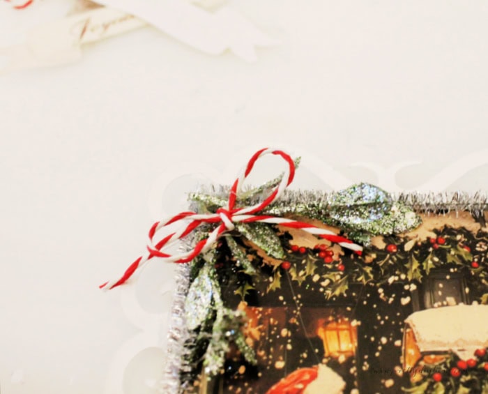 Close up of tiny red and white baker's twine bow used to decor the vintage Santa panel