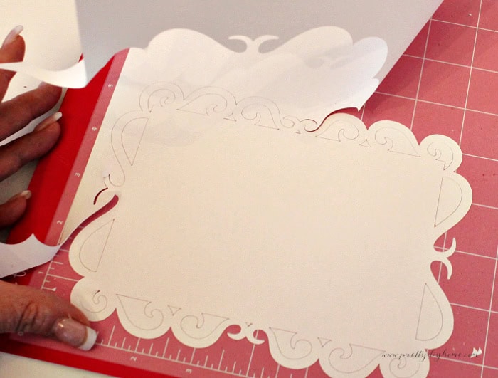Removing the outer cardstock before weeding the delicate areas.