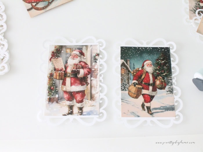 Two vintage Santa postcards glued onto cardstock lace backgrounds with a brayer, lace cutouts, and extra panels shown during assembly.