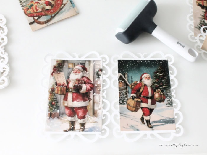 Two santa postcard panels glued to their lace backgrounds during the assembly process.