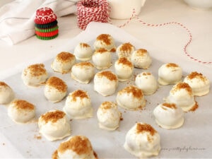 No-bake gingerbread truffles cooling on parchment paper sprinkled with cookie crumbs