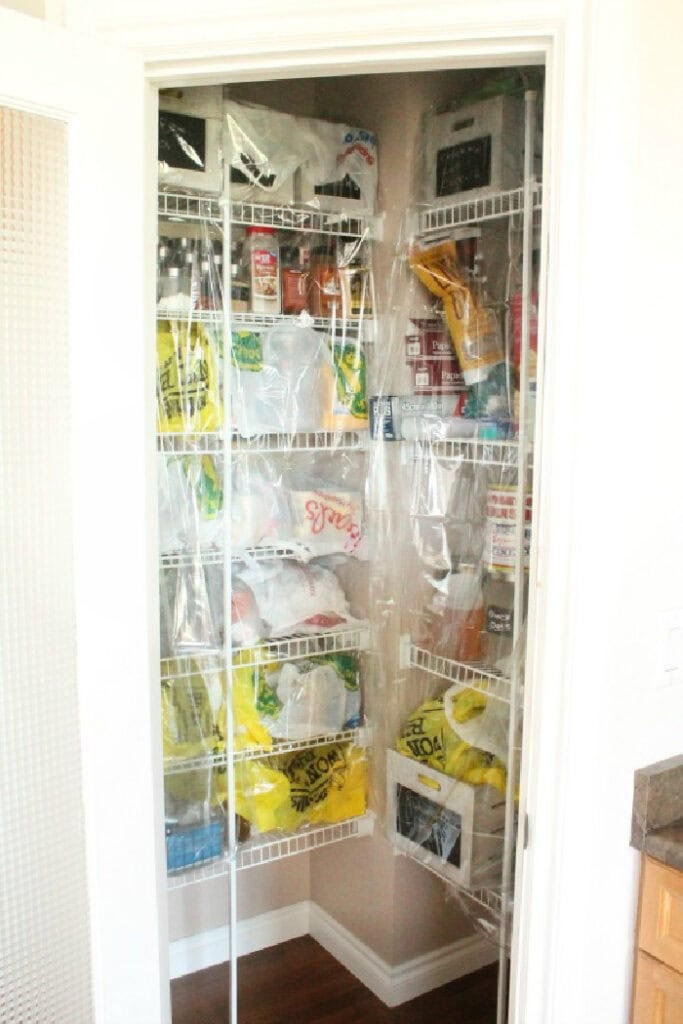 Pantry shelves covered with plastic to protect from dust during hardwood floor refinishing.