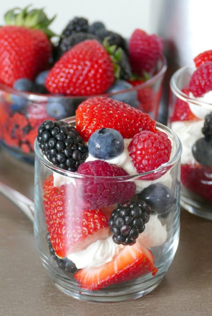 Fresh berries layered with sweet mascarpone cream in dessert cups.