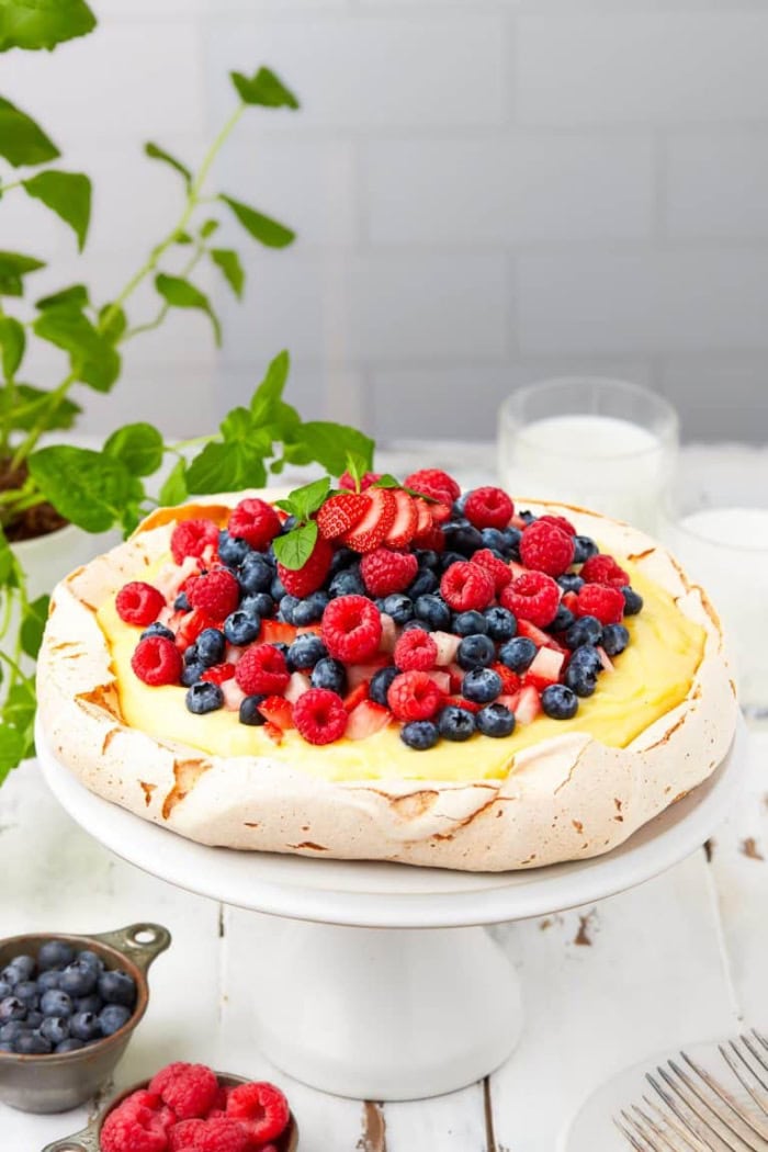 Berry pavlova topped with whipped cream, strawberries, blueberries, and raspberries