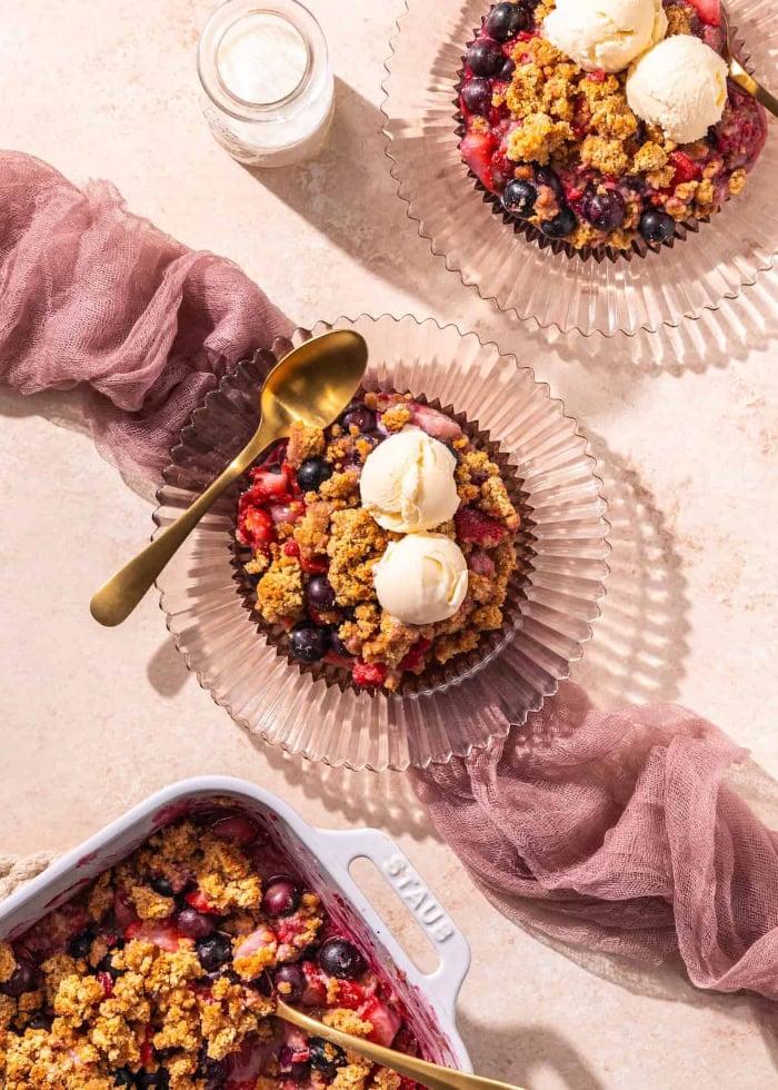 Gluten free berry cobbler served warm with vanilla ice cream.