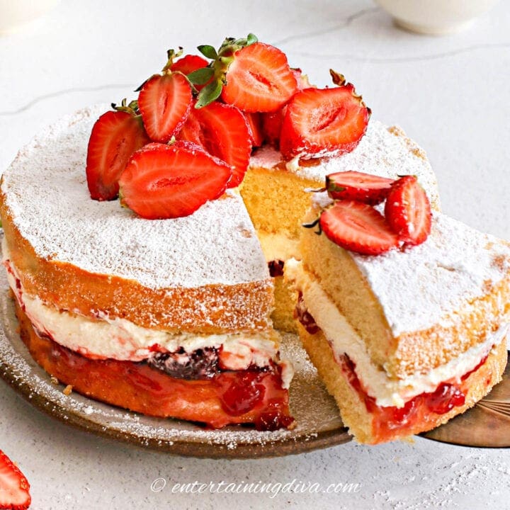Strawberry shortcake cake layered with whipped cream and fresh strawberries.
