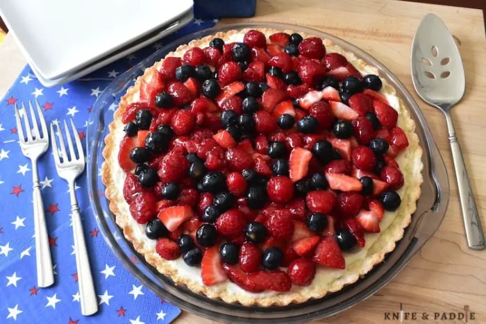 Summer fruit tart topped with fresh strawberries and blueberries.