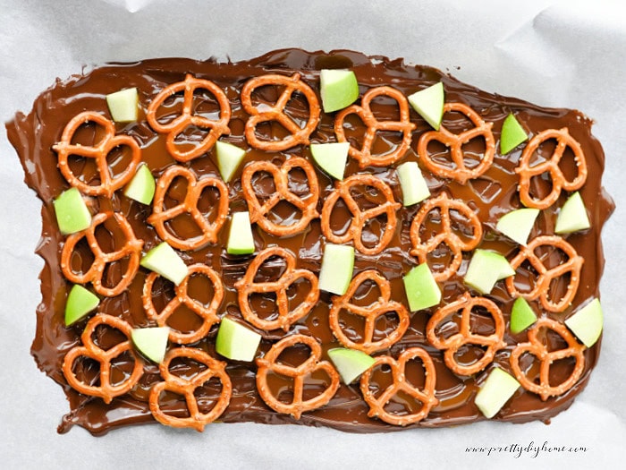 Chopped Granny Smith apples added to the chocolate and pretzel layer while making caramel apple bark.