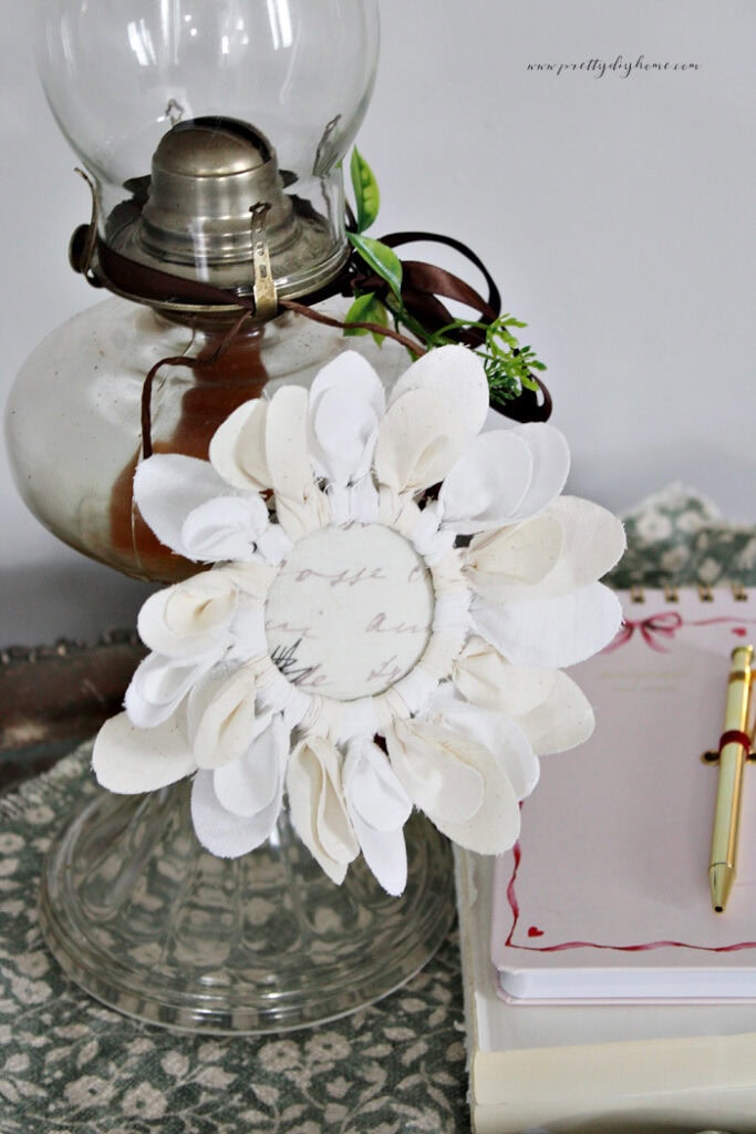 Completed vintage letter fabric flower with a printable letter-inspired center and fabric petals.