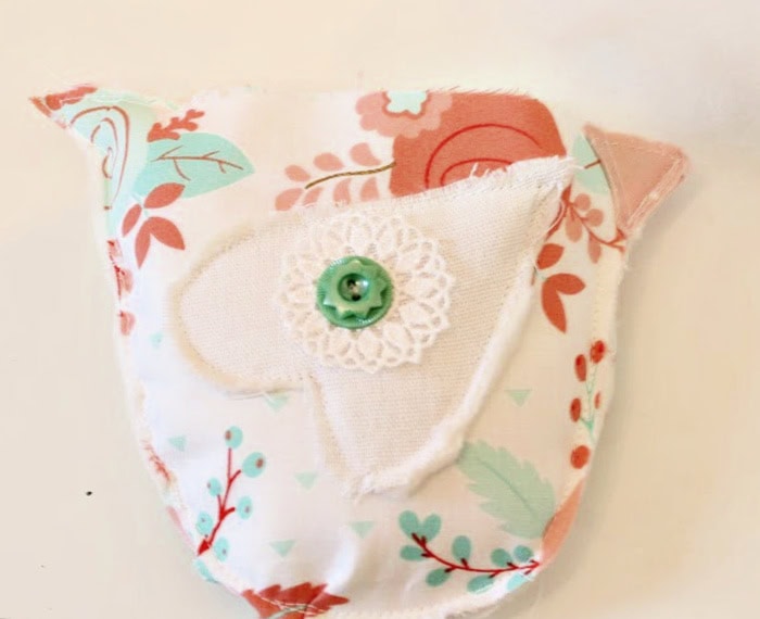 Fabric chicken sewn together with the wings, comb, and beak attached before adding stuffing to create the finished bowl stuffer.