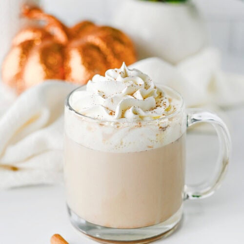 Homemade pumpkin chai latte topped with whipped cream and pumpkin pie spice.