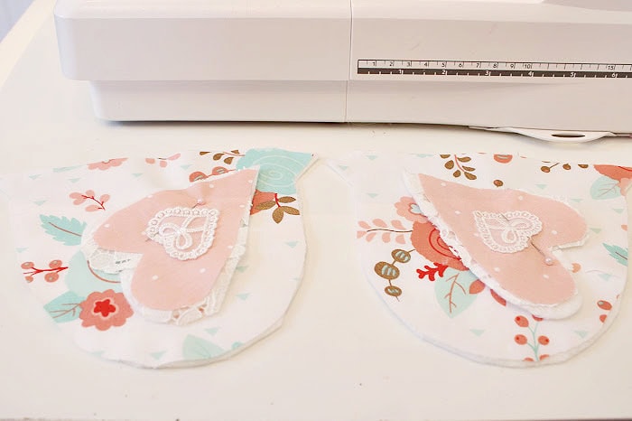 Placing two wings onto the body of a fabric chicken to ensure they are identical before sewing.