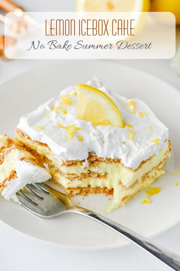 Easy Lemon Icebox Cake topped with whipped cream and a lemon slice on a white plate with visible graham cracker layers.