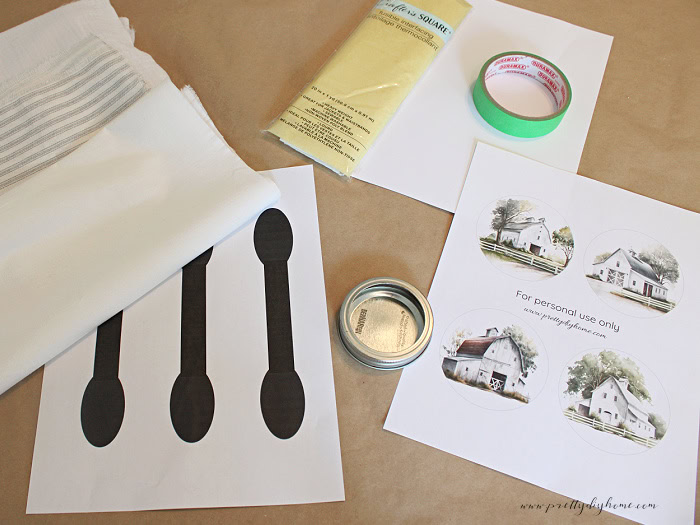 DIY fabric flower supplies including mason jar rings, fabric, printable flower centers, fusible interfacing, scissors, and a flower template.