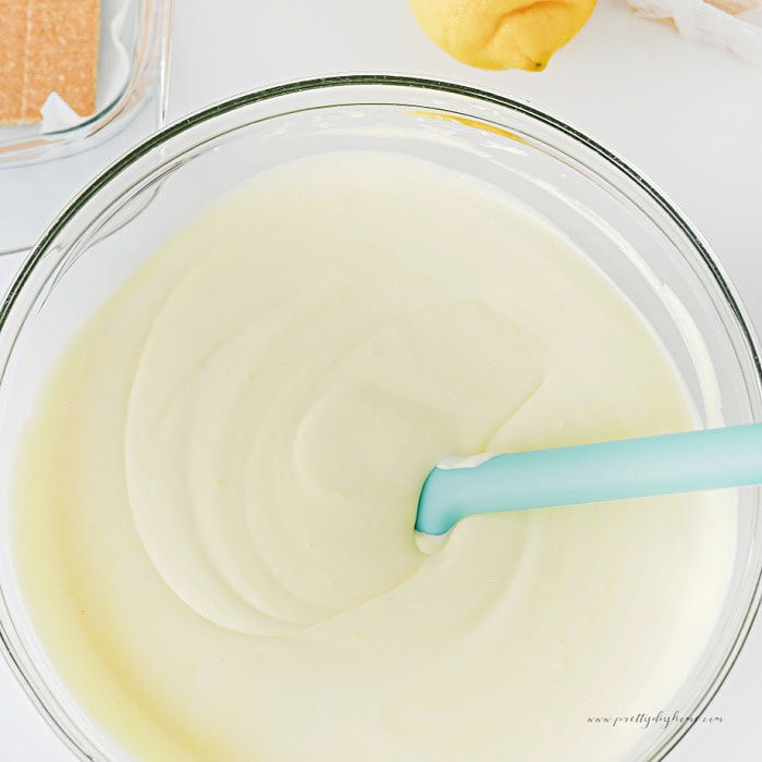 Creamy lemon pudding filling for lemon icebox cake in a clear glass bowl.