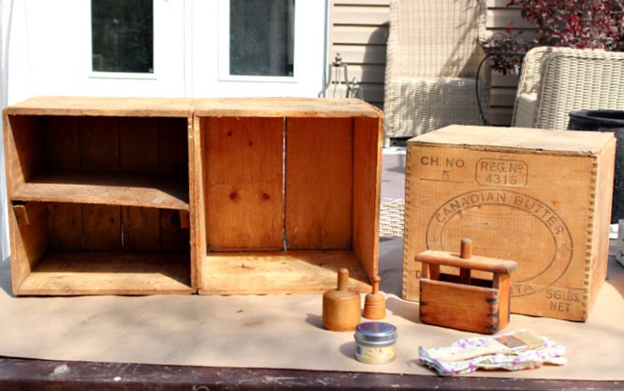 Old wooden butter boxes and vintage butter molds before restoration and conditioning.