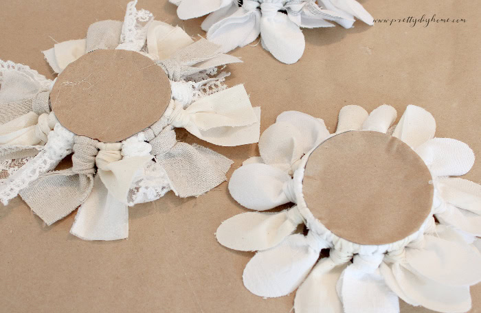 Comparison of fabric flowers with and without an optional cardboard backing.