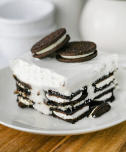 Slice of Oreo Icebox Cake showing the layers of Oreo cookies and cream filling.