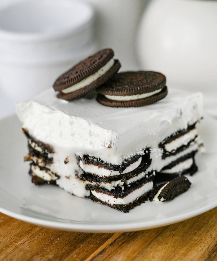 Slice of Oreo Icebox Cake showing the layers of Oreo cookies and cream filling.