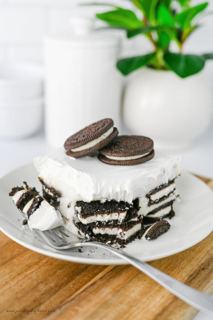 Slice of Oreo Icebox Cake showing layers of Oreo cookies and cream filling.