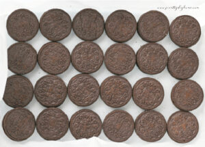 Single layer of Oreo cookies arranged in a parchment-lined baking dish.