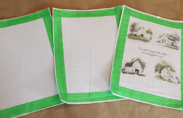 Preparing fabric sheets for printing by taping fabric to paper and securing the edges.
