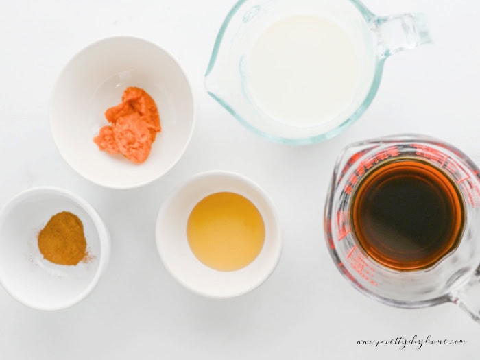 Pumpkin chai latte ingredients including chai tea concentrate, milk, pumpkin puree, pumpkin pie spice, and sweetener.