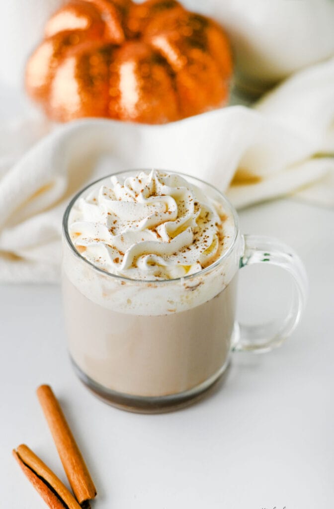 Easy pumpkin chai latte topped with whipped cream and pumpkin pie spice.