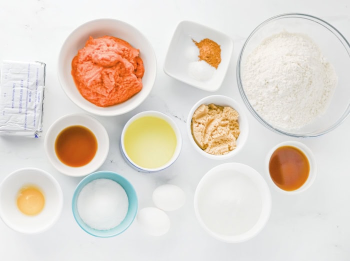 Ingredients needed to make pumpkin cheesecake muffins with cream cheese swirl.
