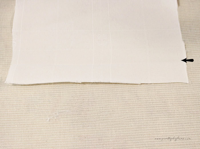 Damask fabric pressed with a half inch fold along the lower edge before making the ruffle.