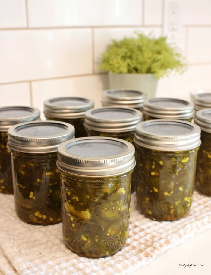 Canned cowboy candy jalapeños in half-pint jars.