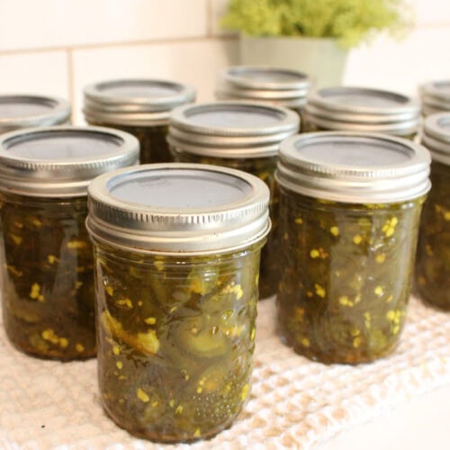 Homemade cowboy candy jalapeños packed in half-pint canning jars.