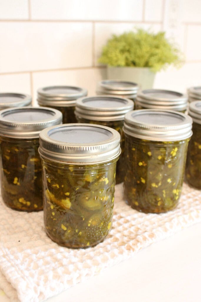 Homemade cowboy candy jalapeños packed in half-pint canning jars.