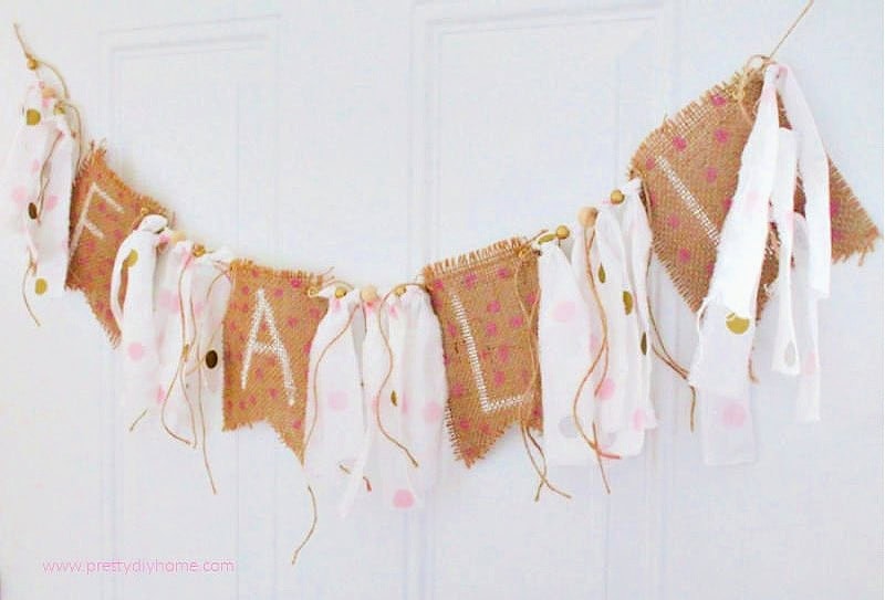 Finished DIY fall burlap banner with white letters, pink polka dots, and fabric ties