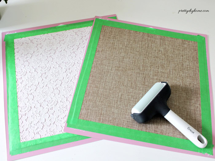 Two fabrics prepared with interfacing are placed on Cricut mats, showing how to position lace and coarse linen before cutting the leaf shapes.
