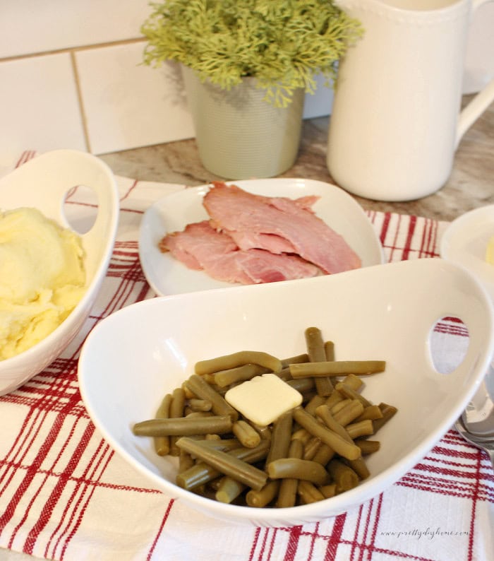 Home canned green beans are served in a bowl with a simple family dinner.