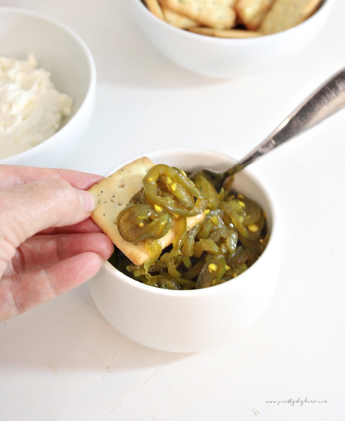 Home canned cowboy candy jalapenos served on a cracker.