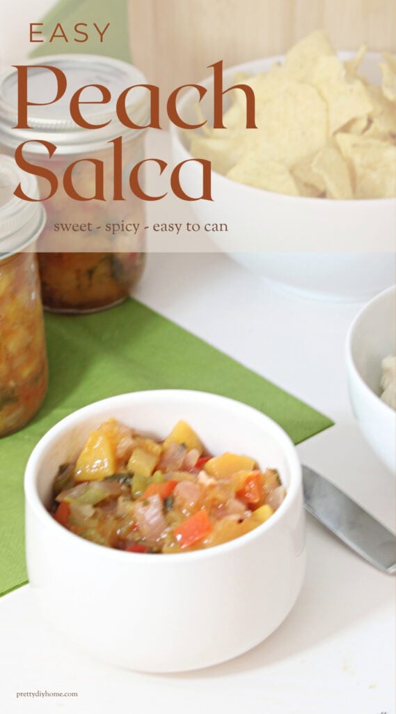 Easy peach salsa for canning served in a bowl with tortilla chips and jars of homemade salsa in the background.