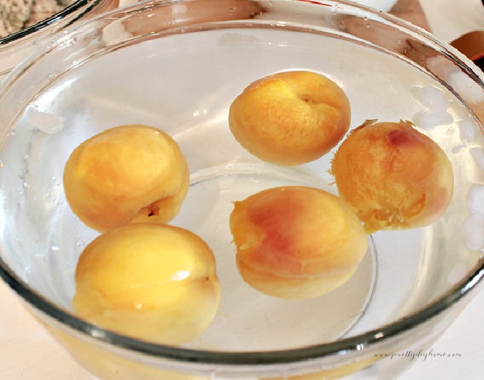 Blanched peaches cooling in an ice water bath before peeling for peach salsa.
