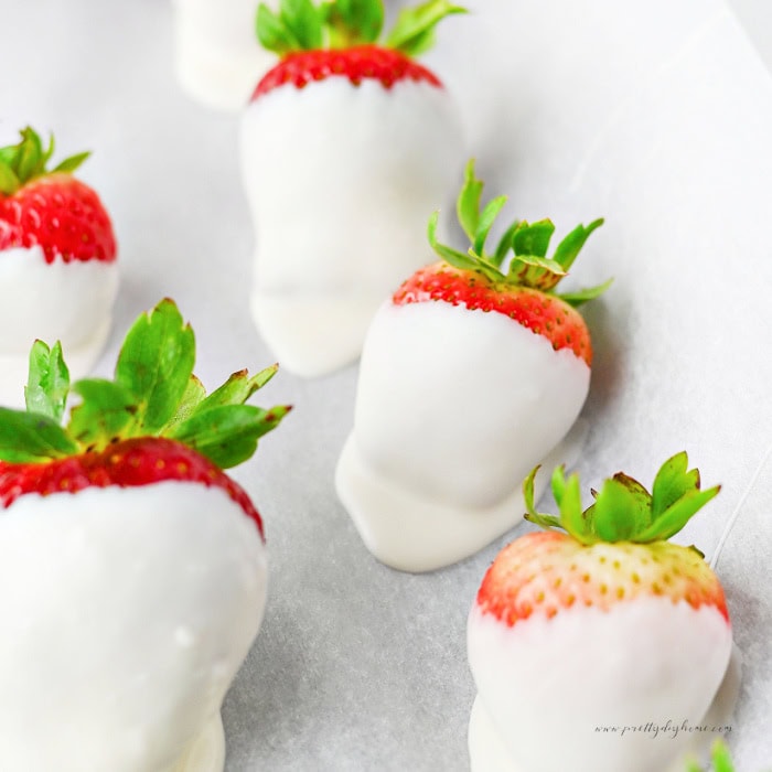 Strawberries dipped in vanilla almond bark before adding the chocolate ghost faces