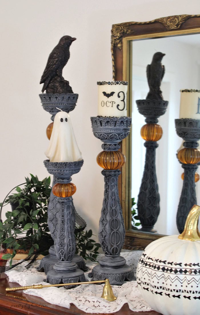DIY Halloween candlesticks with ghost, crow, and OCT 31 candles styled in a vintage Halloween vignette.
