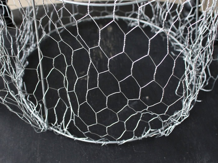 Chicken wire attached around the bottom of a DIY Halloween ghost frame.