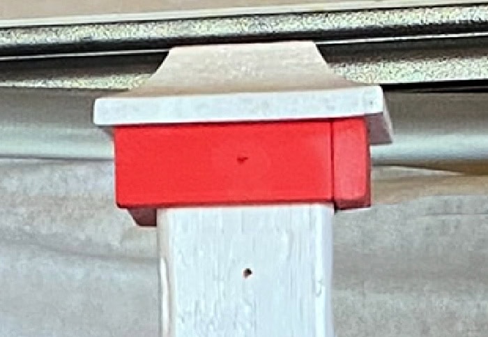 Closeup of wood trim blocks and post cap on a DIY Halloween sign.