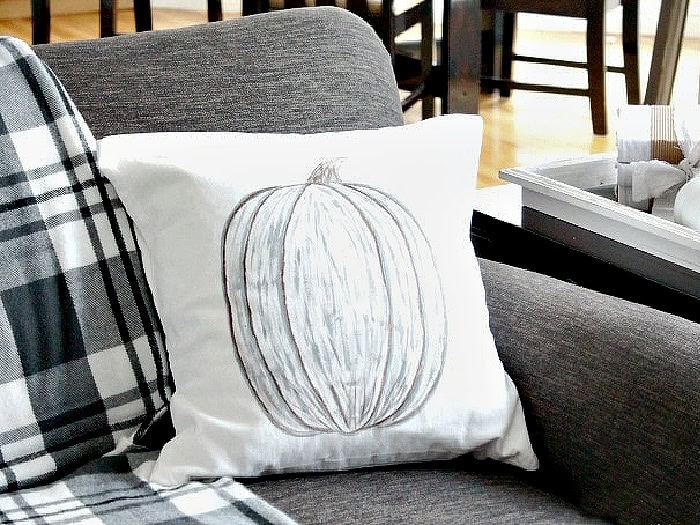 Hand painted pumpkin pillow DIY in neutral grey and white for fall decor.