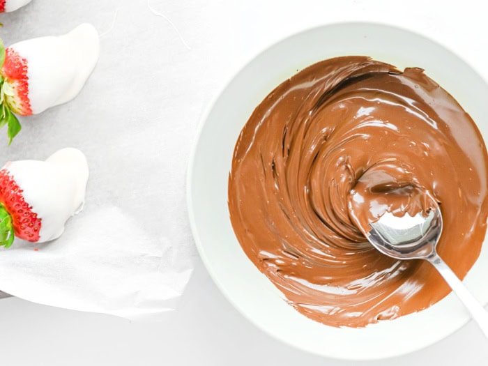 Melted chocolate in a bowl ready for adding faces to the strawberry ghosts.